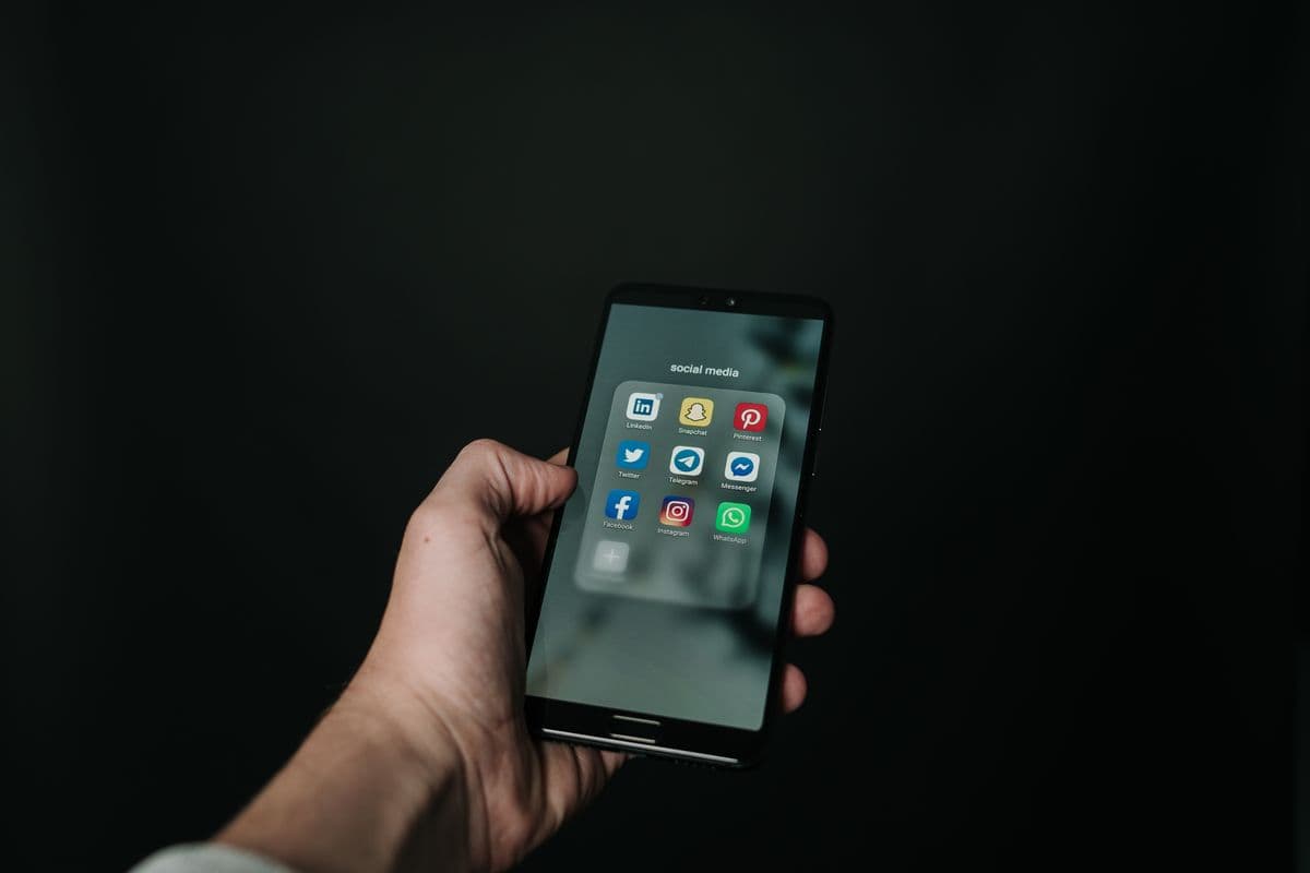 Hand holding a smartphone showing a mobile app