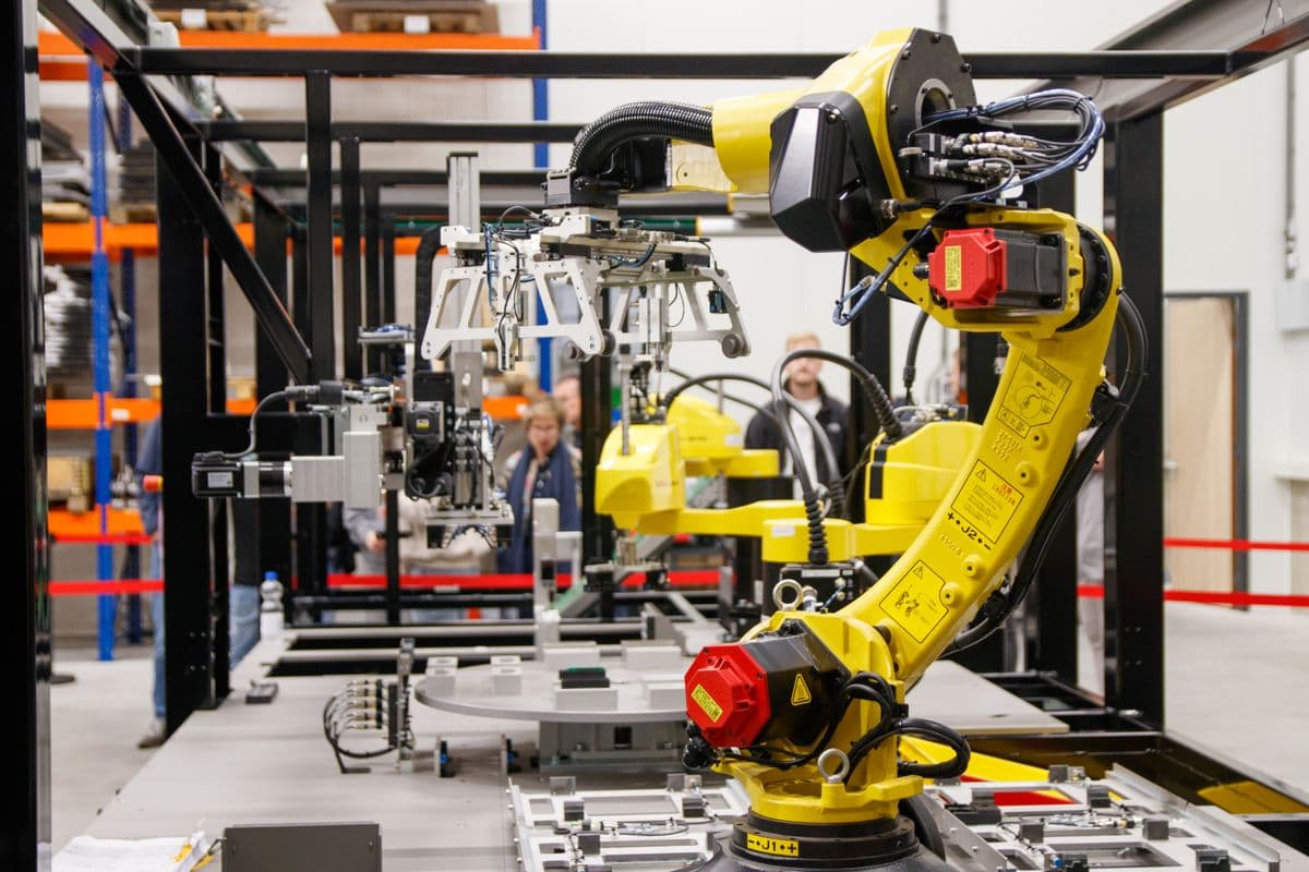 Yellow industrial robot arm working in a modern factory